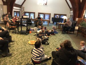 Marv Klassen-Landis reading a holiday story to kids on the Mezzanine.