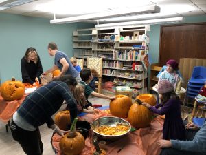 families carving pumpkins