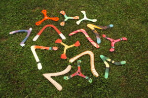 Various boomerangs on the grass.