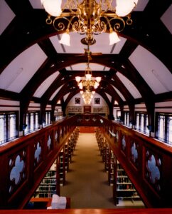 Interior of library showing mezzanine, vaulted ceiling, and chandeliers