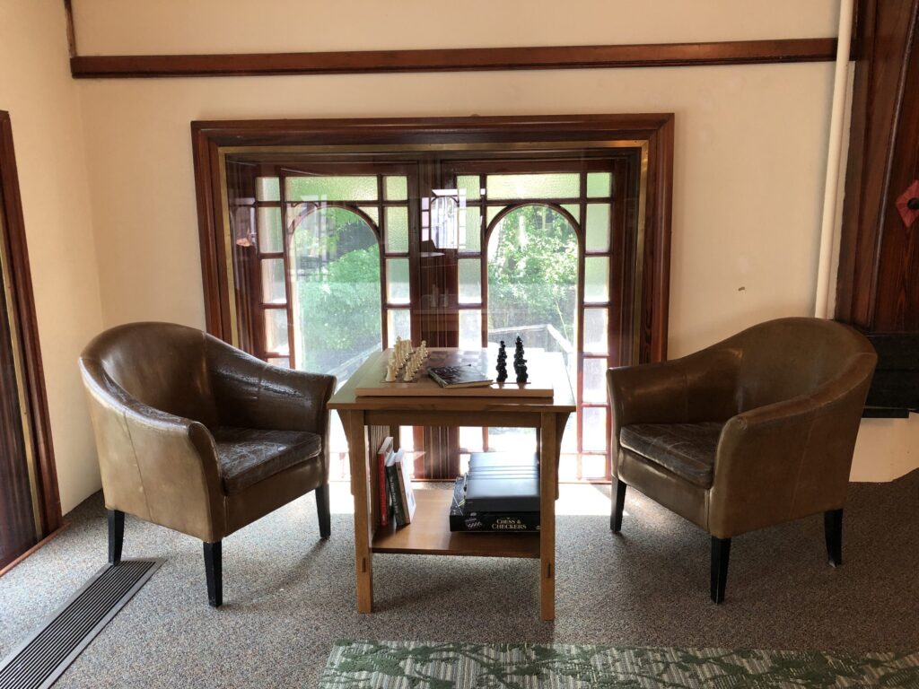 chess set & 2 chairs by window