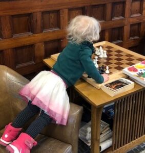 Young girl at chess board
