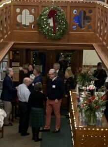 Wassail gathering looking down from the Mezzanine to the wine bar/circulation desk