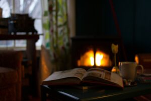 book & mug in front of fireplace