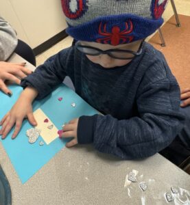 child w spidy hat wearing glasses