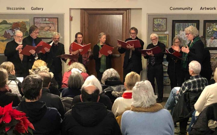 9 singers at NWPL with open red song books